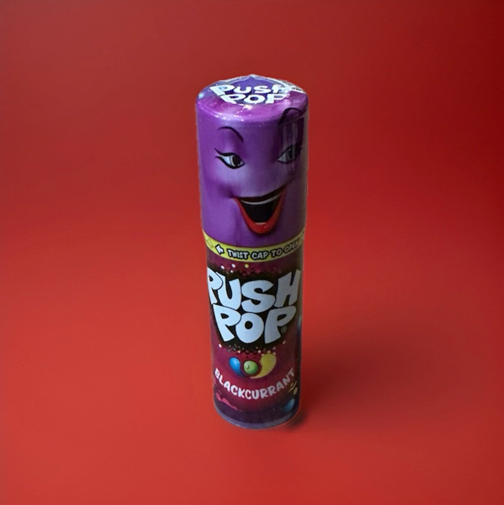 Push up blackcurrant flavour lolly in a purple plastic tube with a purple lid on a red background 