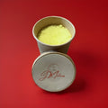Yellow lemon flavoured sherbet in a brown paper pot on a red background 