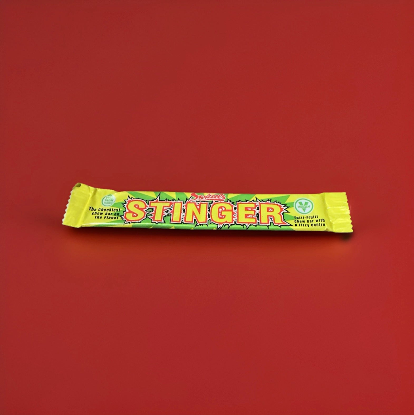 Yellow and green wrapped lemon flavoured chew bar with a fizzy sherbet centre