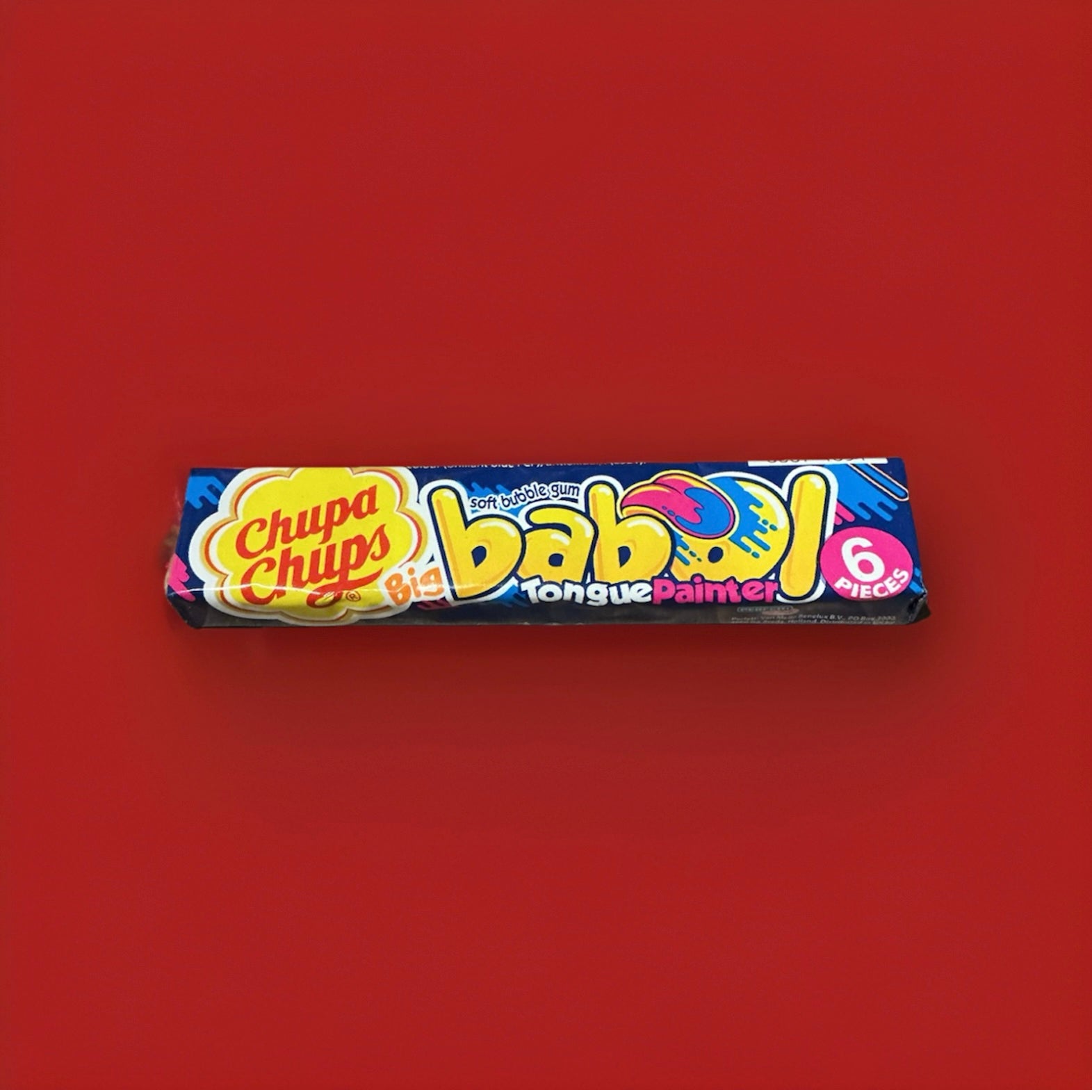 Fruit flavoured tongue painting bubblegum squares in a blue and yellow wrapper on a red background 