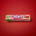 Strawberry flavoured Chewits in a pink wrapper on a red background 