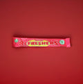Wrapped pink strawberry flavoured refresher chew bar on a red background 