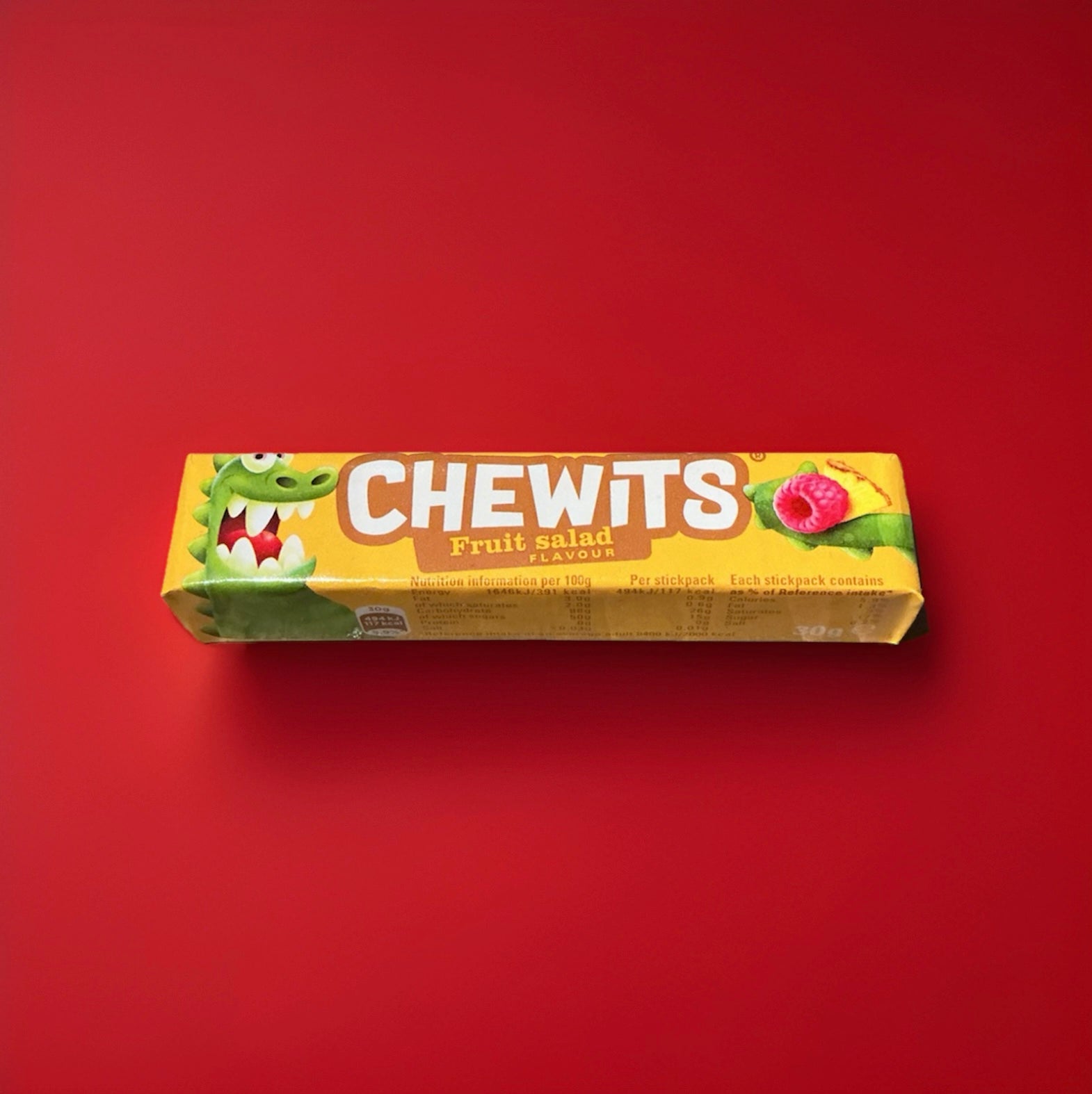 Fruit salad flavoured Chewits in a yellow wrapper on a red background 