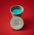 Green lime flavoured sherbet in a brown paper pot on a red background 