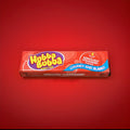 Strawberry flavoured Hubba bubba bubblegum squares in a red wrapper on a red background 