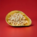 Barratt milk gums powdered dusty milk flavoured bottles in a gold bowl with a red background 