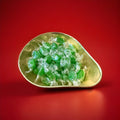 Individually wrapped lime flavoured green coloured hard boiled sweets in a gold bowl on a red background 