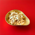 White Barrett milk bottles in a gold bowl on a red background 