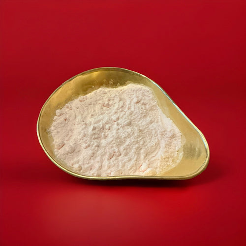 American cream soda sherbet powder in a gold bowl on a red background 