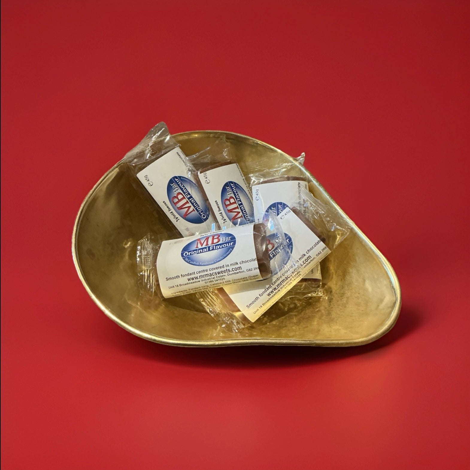 Chocolate and mint fondant flavoured MB Bars in a gold bowl with a red background 