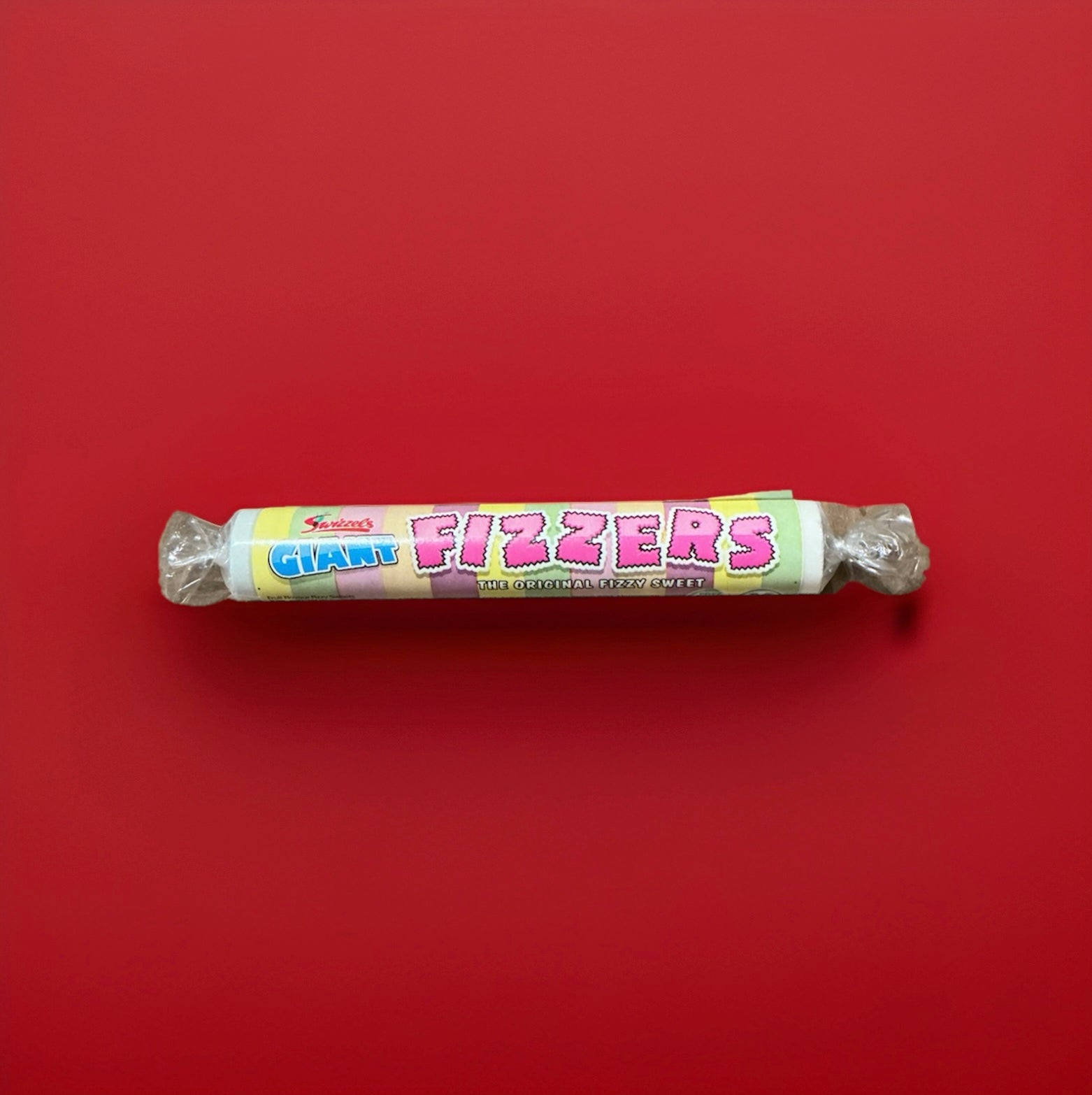 Round fizzy sherbet discs wrapped in multi coloured packaging 