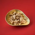 Chunks of winter cough Candy in a gold bowl on a red background 