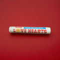 Round sherbet discs wrapped in red and white packaging with a different message on each sweet