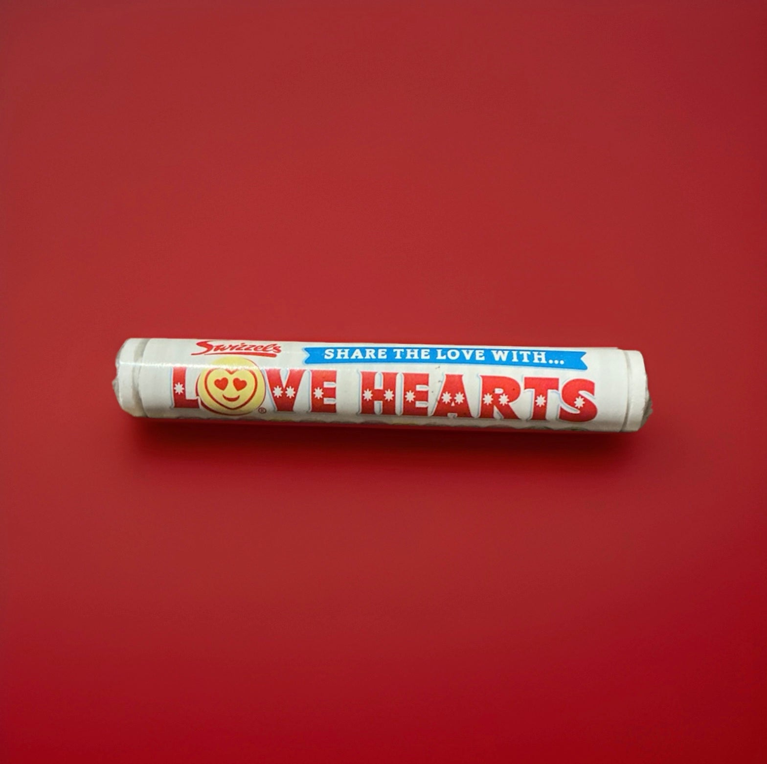 Round sherbet discs wrapped in red and white packaging with a different message on each sweet