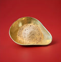 Chock lick chocolate powder in a gold bowl on a red background 