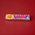 Tutti fruity bubblegum squares in a pink wrapper on a red background 