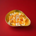 Light and dark orange striped sweets with a pineapple flavour and a sherbet centre 