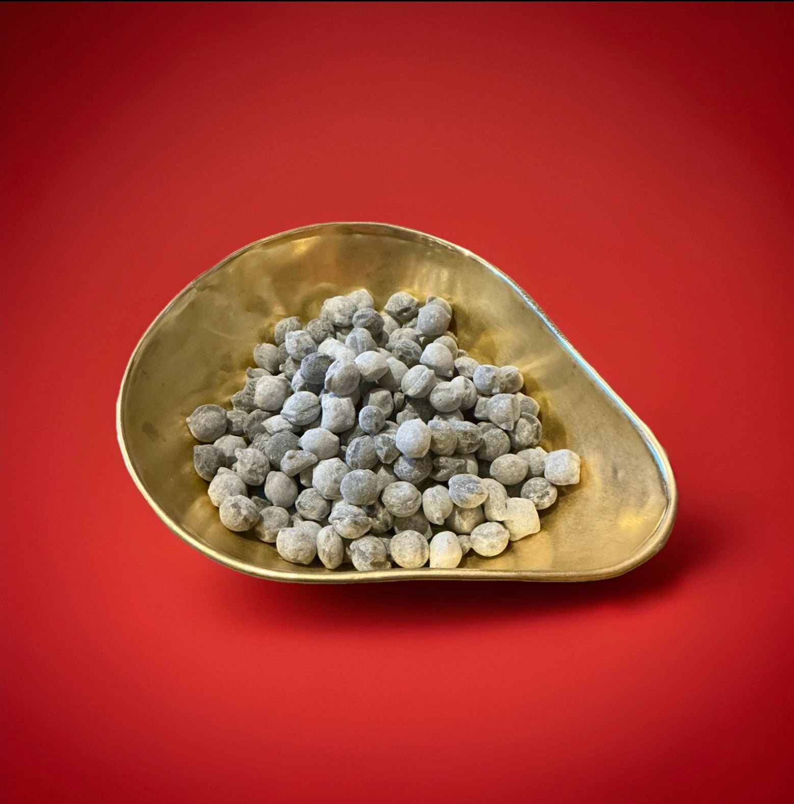 Hard boiled uncle joes winter nips in a gold bowl on a red background 