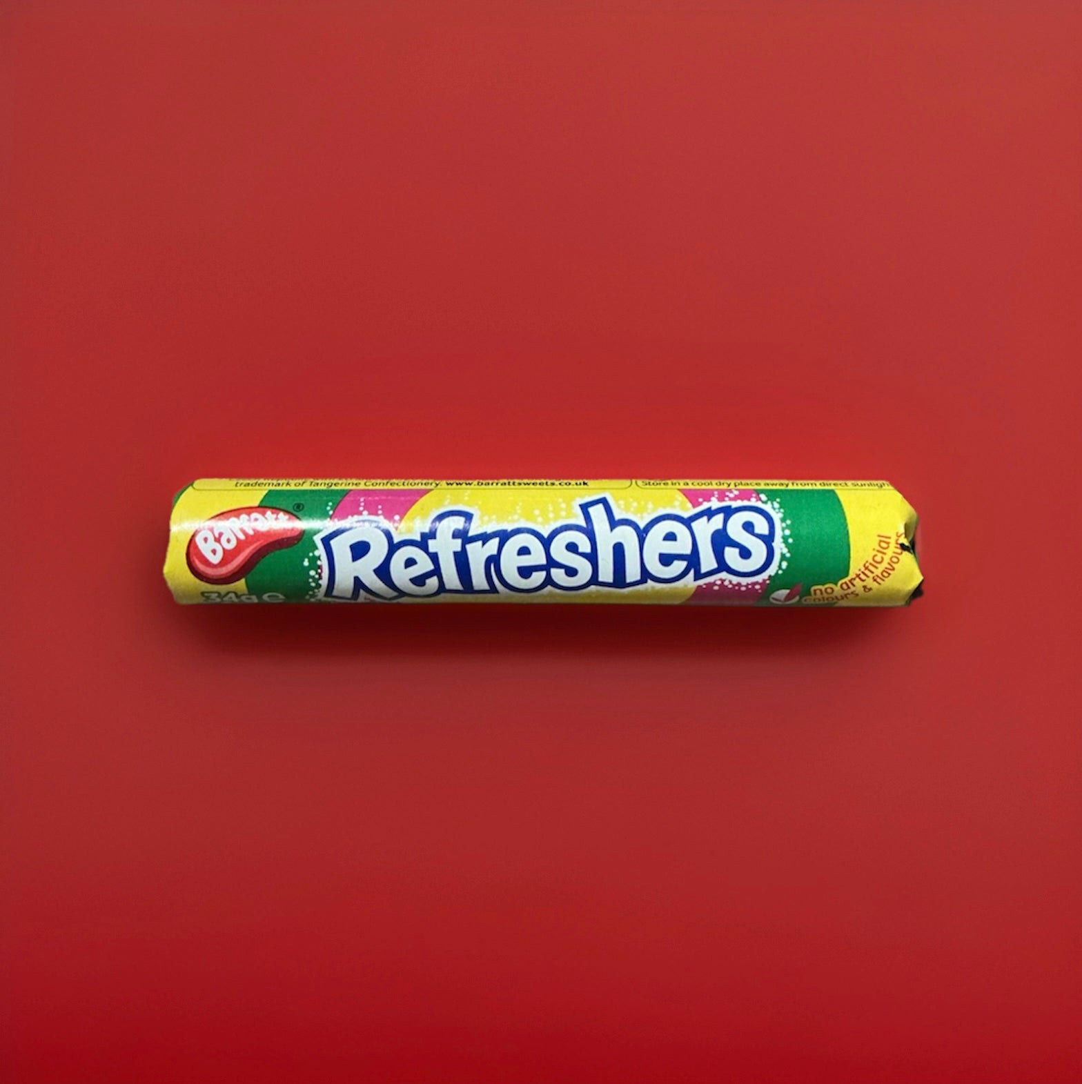 Multicoloured disk-shaped fizzy sweets with a fruit flavour wrapped in multi coloured paper 