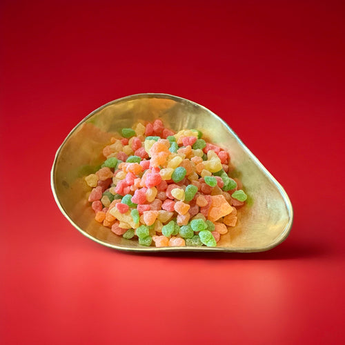 Multicoloured Tom Thumb Drops fruit flavoured pips in a gold bowl with a red background 