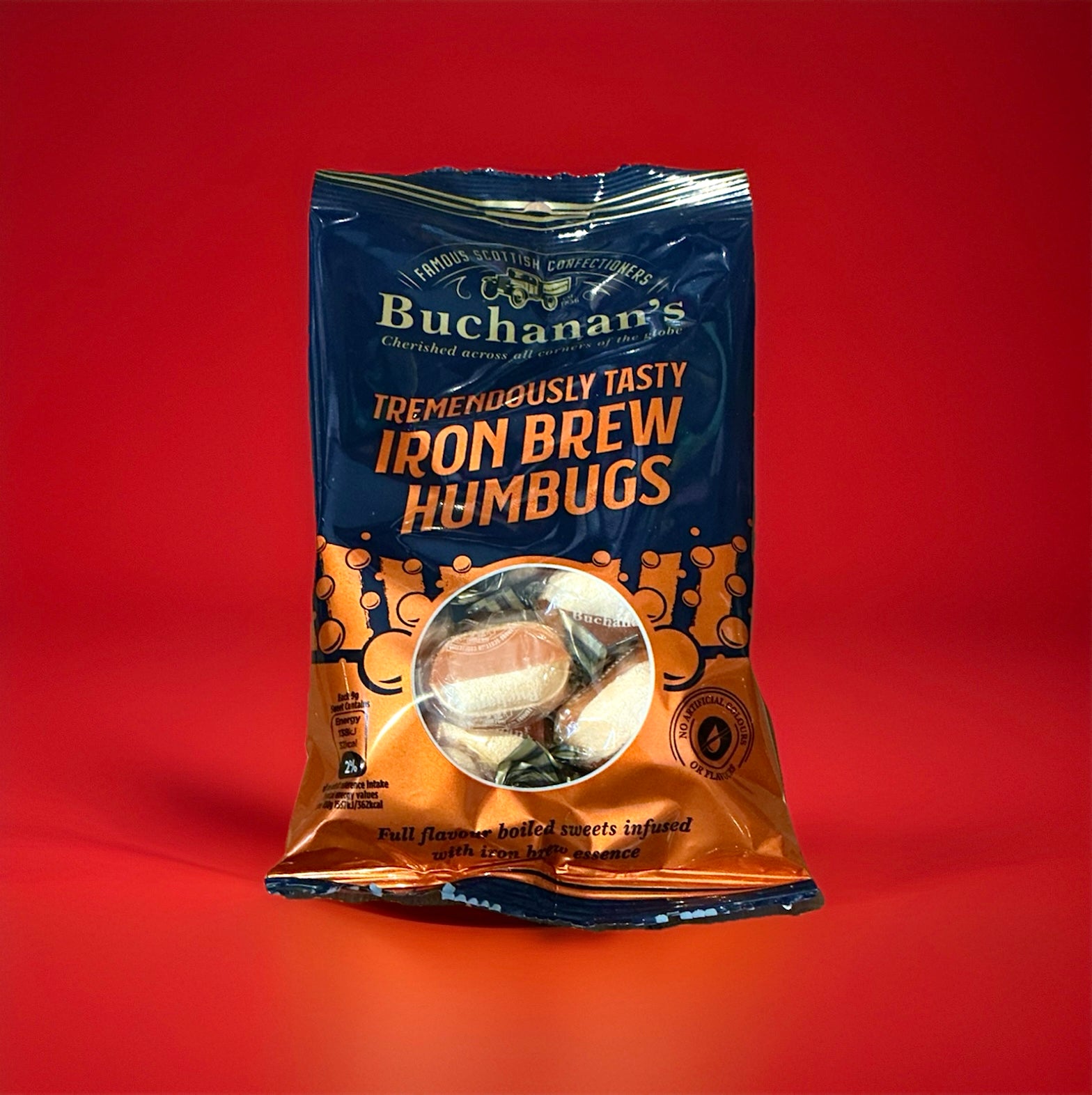 A packet of iron brew humbugs on a red background 
