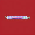 Parma violet flavoured disc shaped sweets in a purple wrapper on a red background 