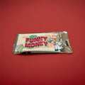 Sheets of rice paper printed to look like money in a clear plastic wrapper on a red background 
