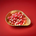 Red and white mint flavoured rock cuttings in a gold bowl with a red background 