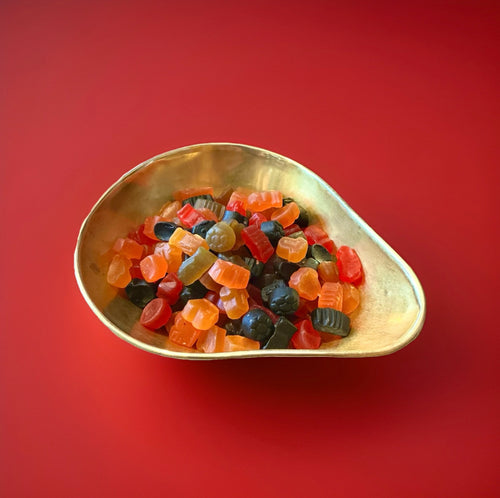 Fruit flavoured lion football mix originally sports mix in a gold bowl with a red background 