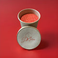 Red strawberry flavoured sherbet in a brown paper pot on a red background 