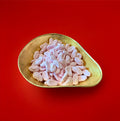 Pink coloured Barratt mini foam shrimps in a gold bowl on a red background 