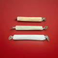 Individually wrapped Edinburgh Castle Rock stick in various fruit flavours on a red background 