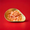 Iron Brew flavoured bottle shaped jelly sweets with a fizzy sugar coating in a gold bowl with a red background 