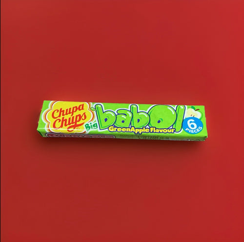 Apple flavoured bubblegum squares in a green wrapper on a red background 