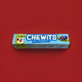 Blue raspberry flavoured Chewits in a blue wrapper on a red background 