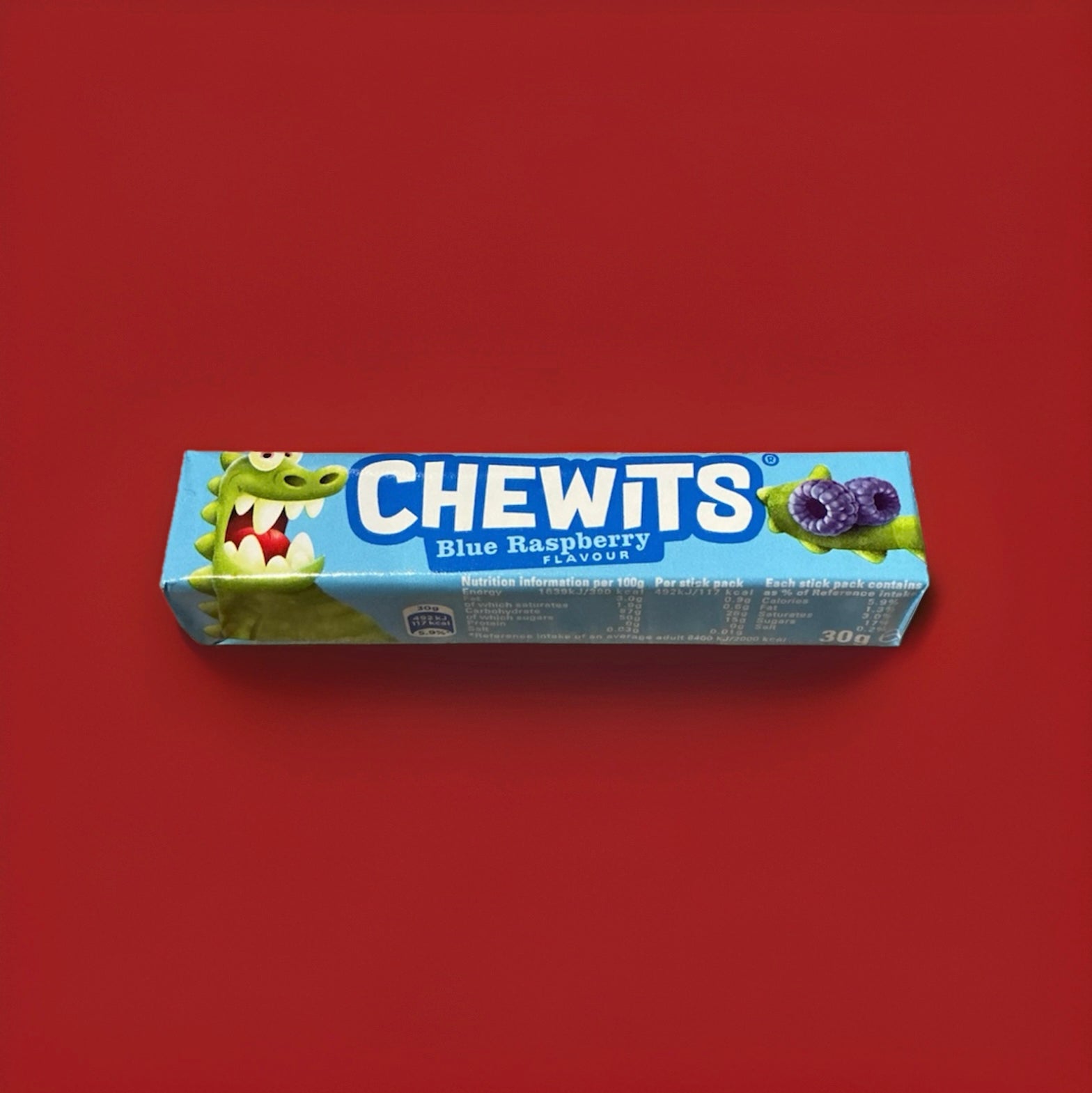 Blue raspberry flavoured Chewits in a blue wrapper on a red background 