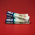 Milk flavoured chewy sweets in a white and blue wrapper on a red background 