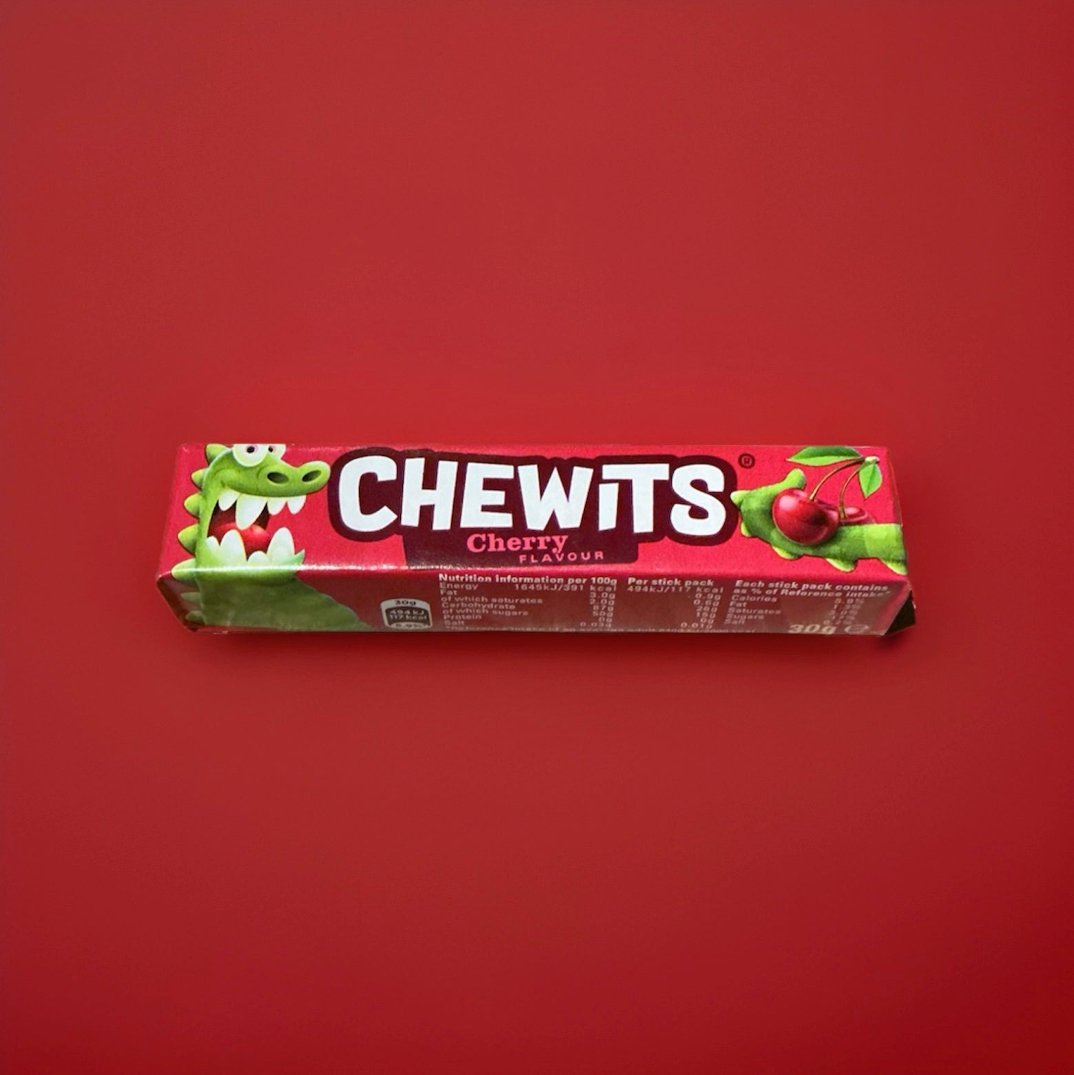 Cherry flavoured Chewits in a red wrapper on a red background 