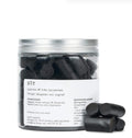 A jar of slow cooked sweet black liquorice with a white background 