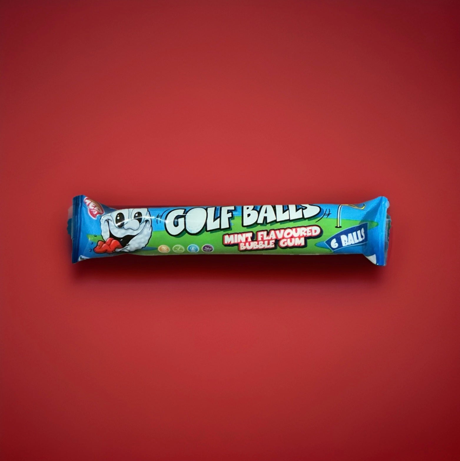 White golf ball shaped mint bubblegum in a blue and green wrapper on a red background 